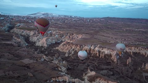 Cappadocia, Turkey – March 3, 2021: Aerial of hot air balloons flying at sunrise, 4k