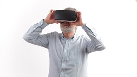 around 50 year old man looking around while having vr goggles on, white background. High quality 4k footage