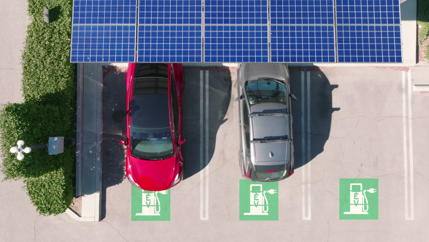 Modern electric car at renewable power solar batteries charging station. Aerial solar panels at urban parking landscape. Futuristic self driving, zero emission and pollution car at EV supercharger Royalty-Free Stock Footage #1088358523