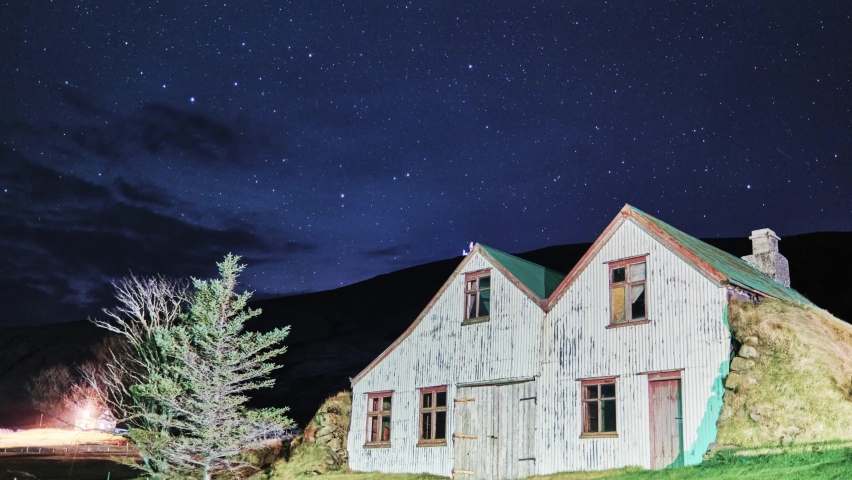 Glowing Stars At The Evening Sky Over Wooden Turf Houses In South Iceland. Timelapse