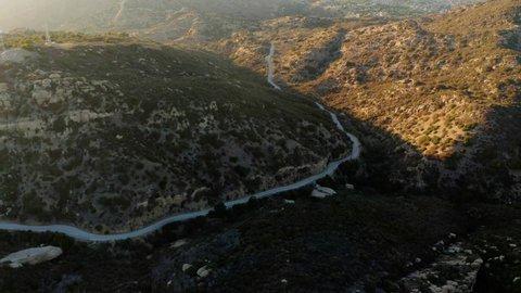 Aerial view overlooking a mountain road in the San Fernando valley - tilt, drone shot