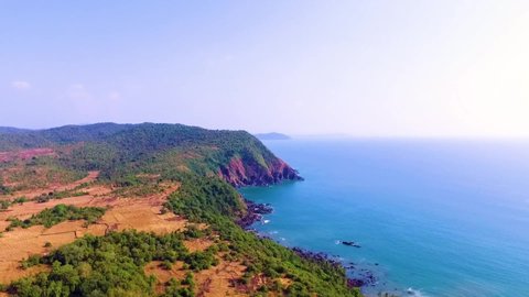 A drone flying over the beautiful cabo de rama beach during the day in south Goa, India.