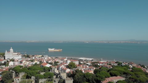Aerial view of Lisbon old town. Flyover Lisbon Castle and Lisbon downtown. Lisbon’s Historic Alfama and Graça Neighborhoods. Rossio plaza.