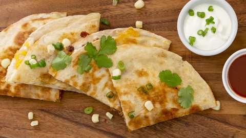 Panning across Quesadilla with sour cream and salsa