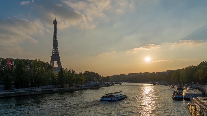 Sunset Over Eiffel Tower in Paris Seine River and Boats Cruises Trees and Clouds | Shutterstock HD Video #1088364751