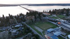 Cinematic 4K aerial drone sunset shot of the 520 Bridge View Park with Medina's expensive homes, views of Laurelhurst, Lake Washington's mansions, luxury homes, villas