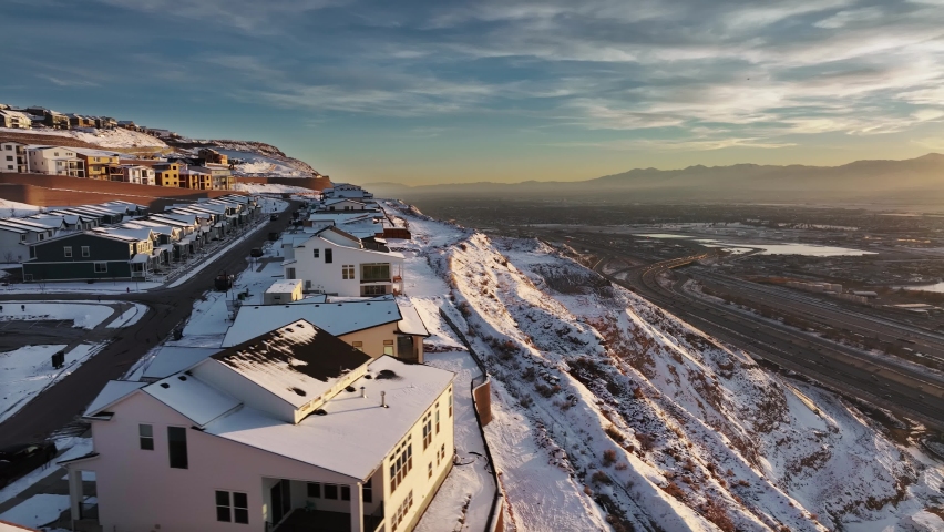 AERIAL - Snowy winter sunrise in Ridge North residential sector, North Salt Lake, Utah
