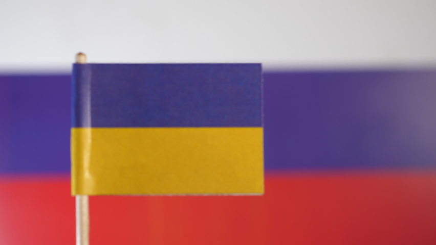 Ukraine and Russia Flags in Rack Focus