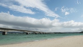 NAKIJIN VILLAGE, OKINAWA, JAPAN - AUGUST 2021 : View around Kouri beach (Ocean or sea). Wide view, time lapse shot in daytime. Sunny summer holiday, vacation and resort concept video.