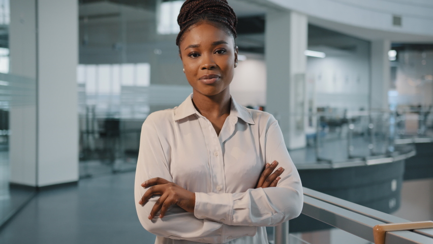 African millennial 30s successful confident strong businesswoman feminism worker lady boss female leader multiracial woman in formal shirt posing crossing arms looking at camera in office corporate Royalty-Free Stock Footage #1088367575
