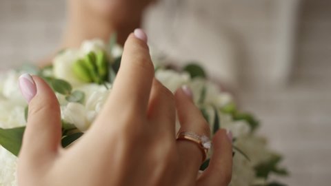 bride's hand on wedding bouquet in the morning	