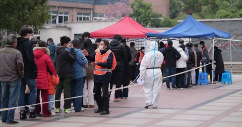 Shanghai,China-March 19th 2022:  many Chinese people line up to receive nucleic acid test for Covid-19 coronavirus at local community. Shanghai is seeing a resurgence of covid-19 Omicron