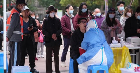 Shanghai,China-March 19th 2022: Many Chinese residents lining up to receive nucleic acid tests for covid-19 coronavirus at community in Pudong district. Shanghai is  seeing a resurgence of Omicron