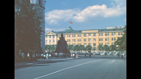Moscow, Russia - 1985: Tsar Bell in Ivanovskaya square with Kremlin Senate Palace with red Flag of the Soviet Union. Archival of Russia in the 1980s.