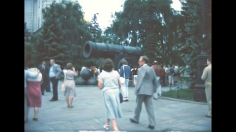 Moscow, Russia - 1985: tourists visiting the Tsar Cannon of Moscow the largest bombard by caliber in the world. Located on Ivanovskaya Square by the Kremlin Armory. Archival of Russia in the 1980s.