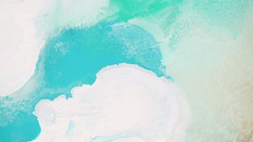 Fluid art drawing video, modern paint texture with flowing effect. Liquid backdrop with foam and waves, splash and swirl. Abstract background similar to the landscape of the ocean.