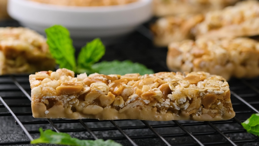 Taking Peanuts butter Cereal Bars with nuts, oat and honey. Healthy Protein snack Royalty-Free Stock Footage #1088374767