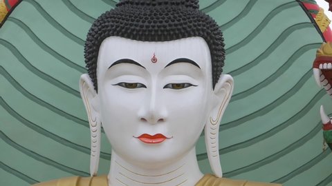 Buddha face in buddhism temple on green background
