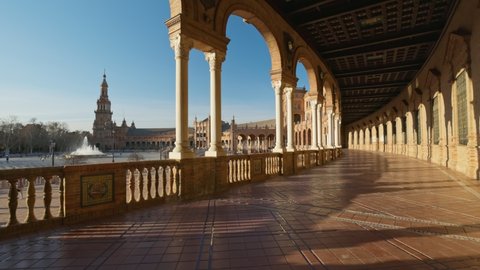 Camera moves along the corridor with columns in Plaza de Espana - Spanish Square -, Sevilla, Spain. Walking through Plaza de Espana complex. Gimbal high quality shot, 4K