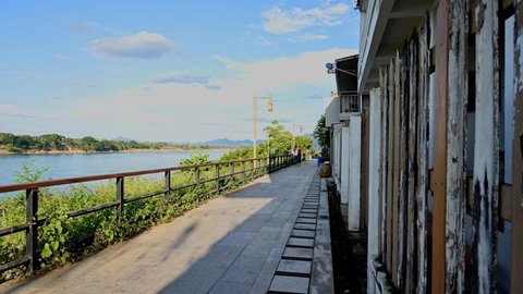 Chiang Khan , Loei , Thailand - 01 01 2022: Time lapse of people going up and down the Walking Street next to the Mekong River, Chiang Khan, Loei in Thailand.