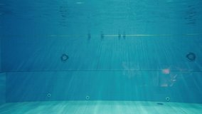 Underwater couple of kids dive in to swimming pool water in modern swimwear and diving mask glass ready to swim and play in apnea - Powered by Shutterstock - Get 15% off with code: PIKWIZARD15