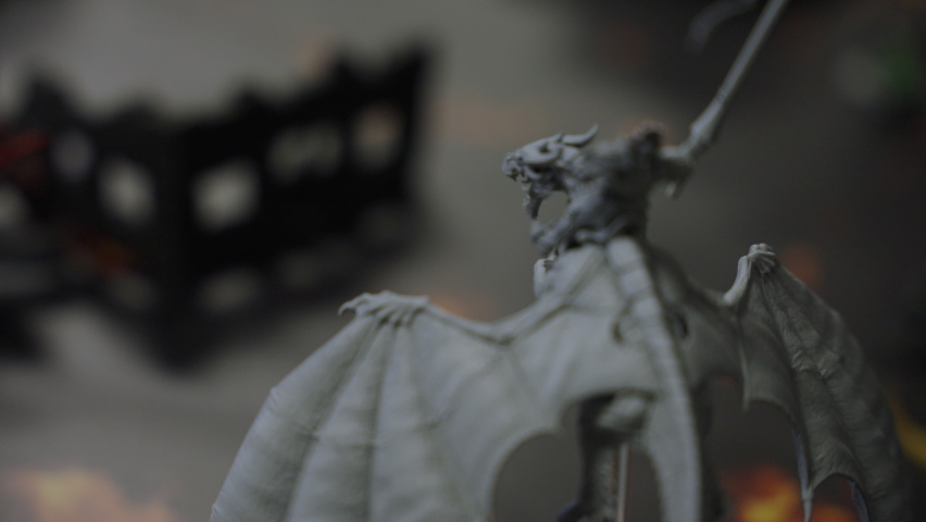 Rack focus fantasy miniature dragon on game board playing roll playing slow motion 4K