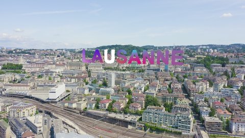 Inscription on video. Lausanne, Switzerland. Flight over the central part of the city. La Cite is a district historical centre. Lightning strikes the letters, Aerial View