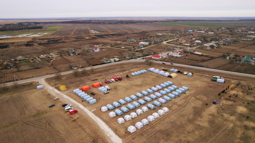 Refugees from Ukraine. Land arranged on the territory of Moldova with tents near the border of Ukraine for refugees coming from the war in Ukraine. Refugee camp with many shelter and living place.