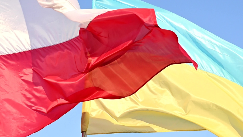 Developing waving  Ukrainian and Polish flags on a blue peaceful sky, support for friendly countries  war in Ukraine Royalty-Free Stock Footage #1088383003