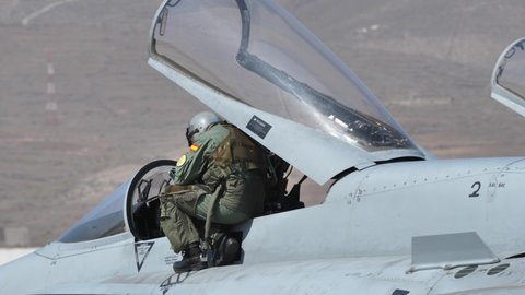 Gran Canaria Spain OCTOBER, 21, 2021 Military pilot descends from the cockpit of a modern supersonic fighter jet of NATO. Boeing F-18 Hornet of Spanish Air Force. Close-up 4k high quality video