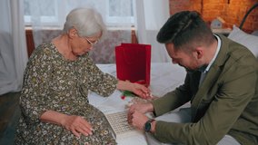 relatives, grandmother and her oldest grandson playing vocabulary puzzles together in her bedroom. High quality 4k footage - Powered by Shutterstock - Get 15% off with code: PIKWIZARD15