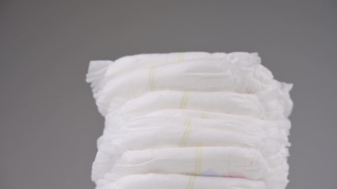 Pile of baby diaper panties diaper isolated on background, close-up, copy space, infant