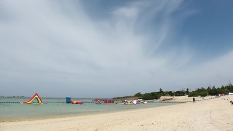 YOMITANSON, OKINAWA, JAPAN - AUGUST 2021 : View of Zanpa beach (Ocean or sea). Wide view, time lapse shot in sunny daytime. Summer holiday, vacation and resort concept video.