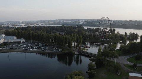 ferris wheel. flying in the air, an island in the center of Irkutsk. summer, bridge on the background