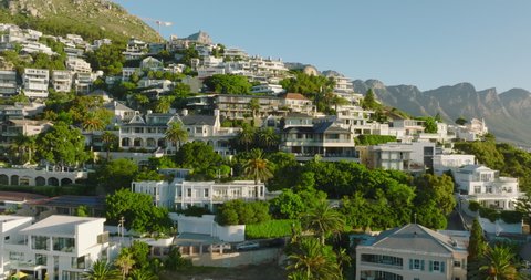 Slider of luxurious houses in sunny slope. Fly above tropical tourist destination. Cape Town, South Africa