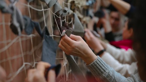 Ukraine, Chernivtsi - March 4, 2022: A camouflage net made of pieces of cloth helps soldiers to hide from enemy during the war. The net is woven by women volunteers who want to help their military win