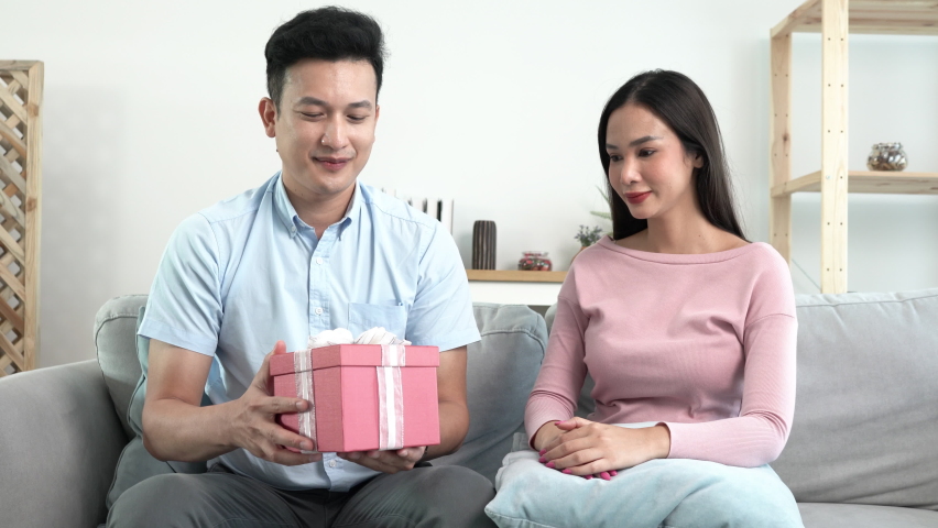 husband giving Gift his wife makes surprise. beloved man hold giftbox express gratitude for gift at 8-march International Women Day, life events celebrations concept
 Royalty-Free Stock Footage #1088399825
