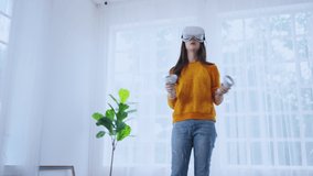 exitied enjoy 3d virtual gaming futuristic experience young asian female wear vr headset technology watching simulation digital world hand gesture control herself to beat the online fun virtual gaming