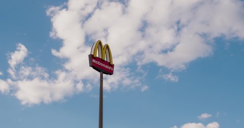 Pirmasens, Germany - MAR 19, 2022: Mcdonald's sign in front of a blue sky with white clouds