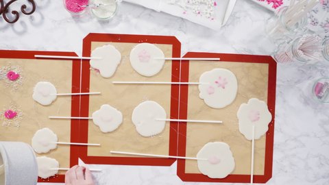 Time lapse. Flat lay. Pouring caramelized sugar on silicone mats to make homemade lollipops.