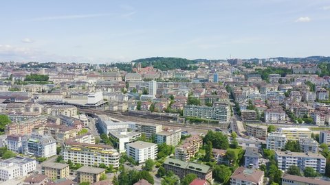 Inscription on video. Lausanne, Switzerland. Flight over the central part of the city. La Cite is a district historical centre. Different colors letters appears behind small squares, Aerial View
