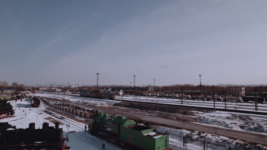 The train travels along the railway tracks in winter