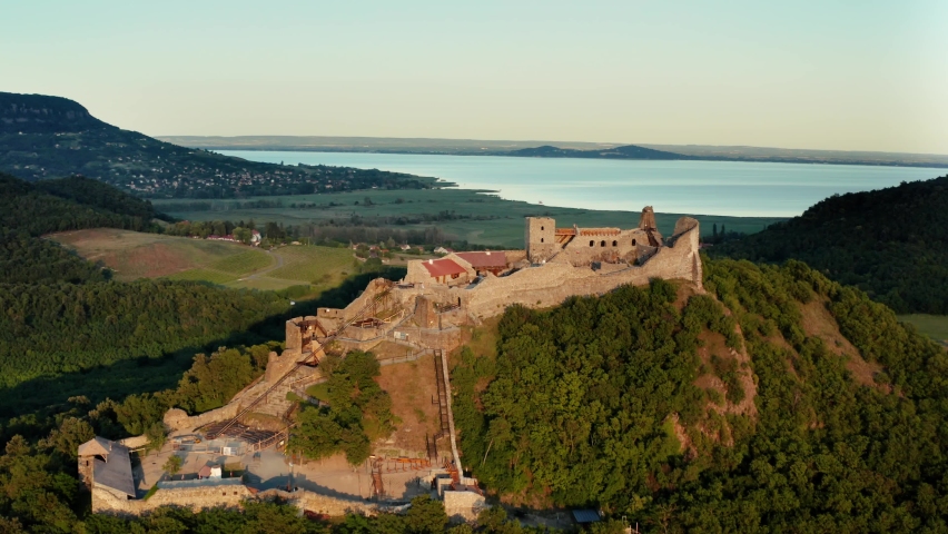 Castle of Szigliget medieval fortress on a hill in Balaton Uplands, aerial view drone shot