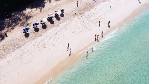 Aerial drone top view crowd of people at tropical Beach with sunset in Phuket, Thailand, Beautiful Phuket beach is famous tourist destination at Andaman sea. Top view happy people play on the beach