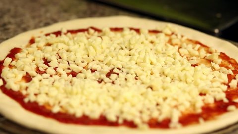 Pizzaiolo adds tomatoes to mozzarella dough. Preparing pizza margherita. Pizzeria. takeaway pizza