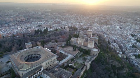 Alhambra castle in Granada at sunset, aerial view of famous Spanish landmark, moorish medieval historic monument in Spain, flying above fortress of Granada. High quality 4k footage