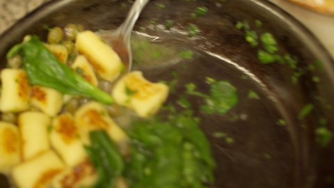 put freshly fried gnocchi on a plate, close-up view, top view, 4k video