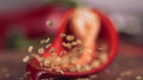 Slow Motion of Grains from Red Chilli Pepper with Knife