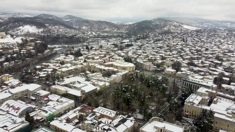 Kutaisi, Georgia - March 18, 2022: Aerial view on Kutaisi city centre with snow on the roofs.
