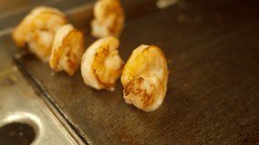 large shrimp being fried in a pan, close-up video